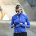 Jogger selecting music on smartphone